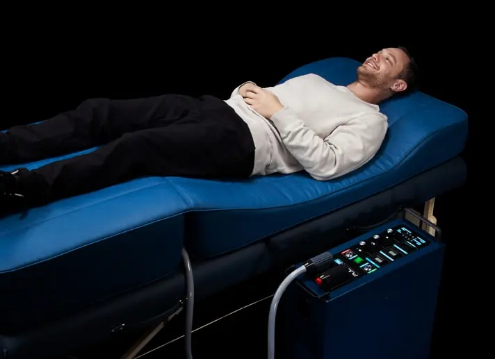 Patient receiving PEMF electromagnetic field therapy for pain relief and healing